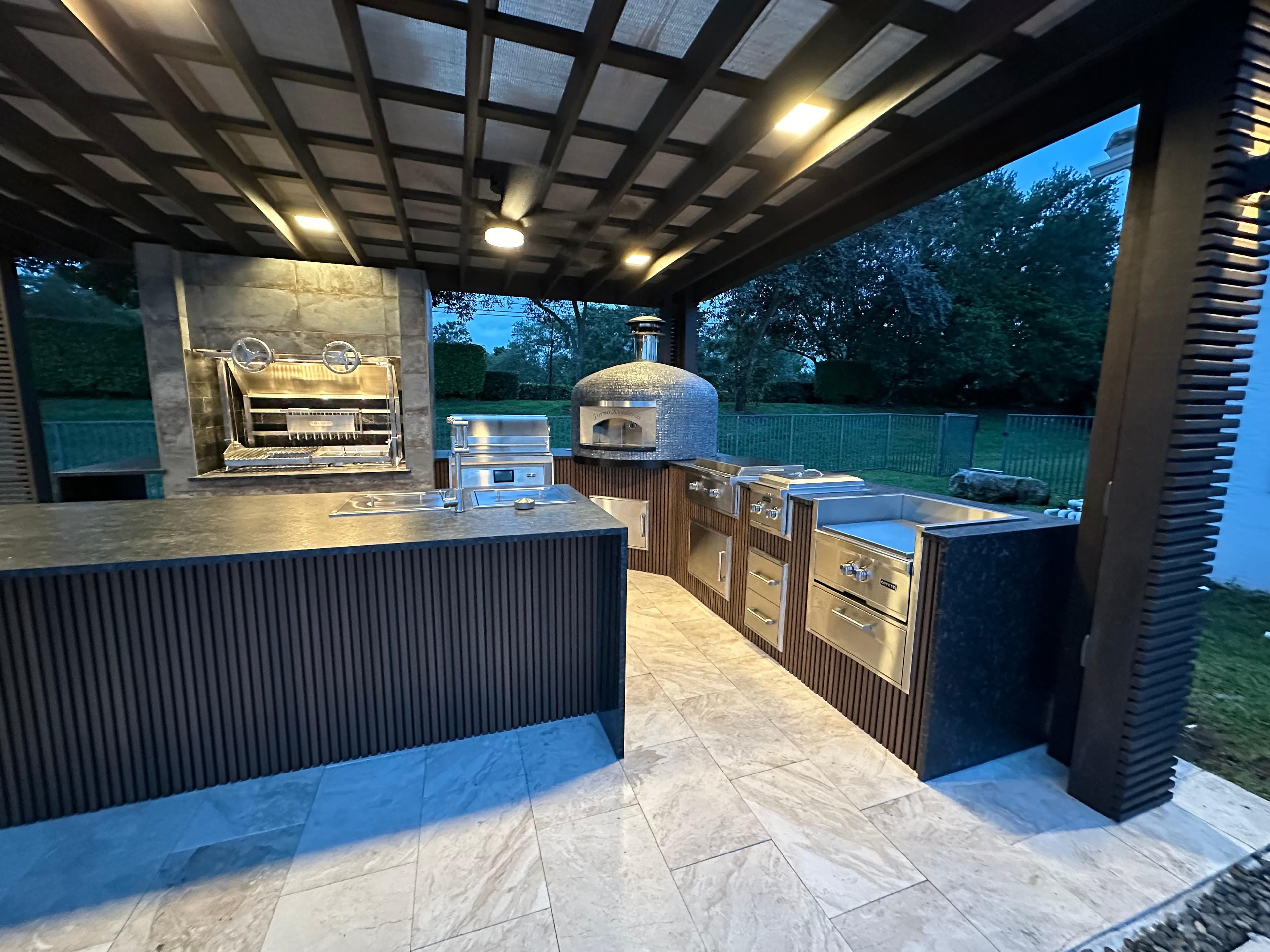 Luxury outdoor kitchen with pergola and pizza oven