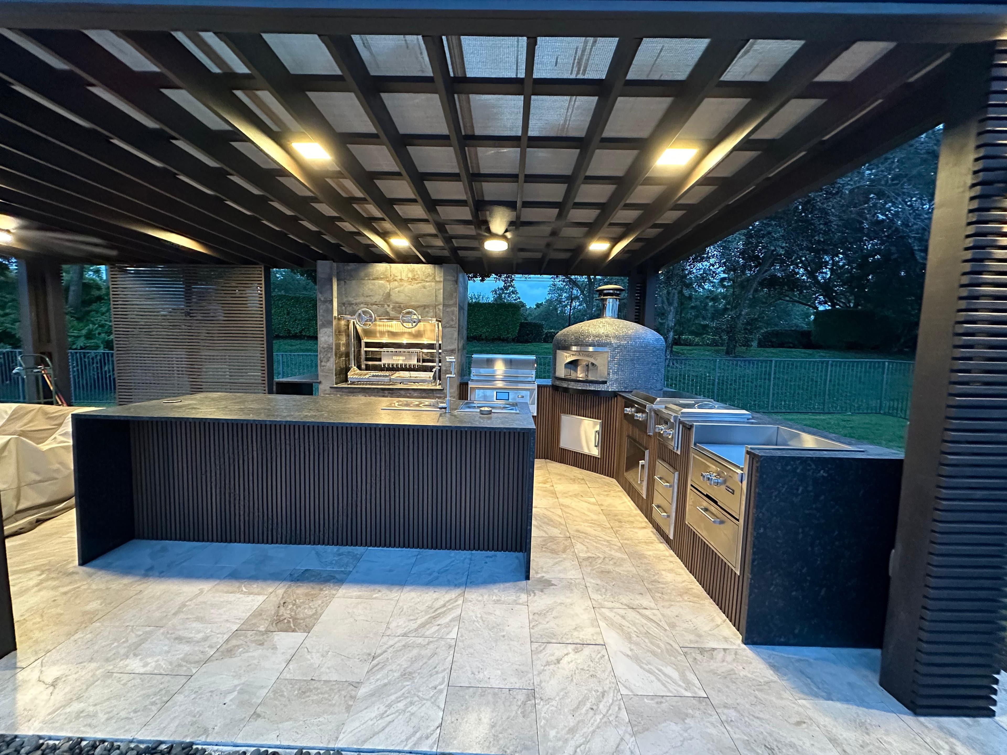 Luxury outdoor kitchen with bar and pergola shade