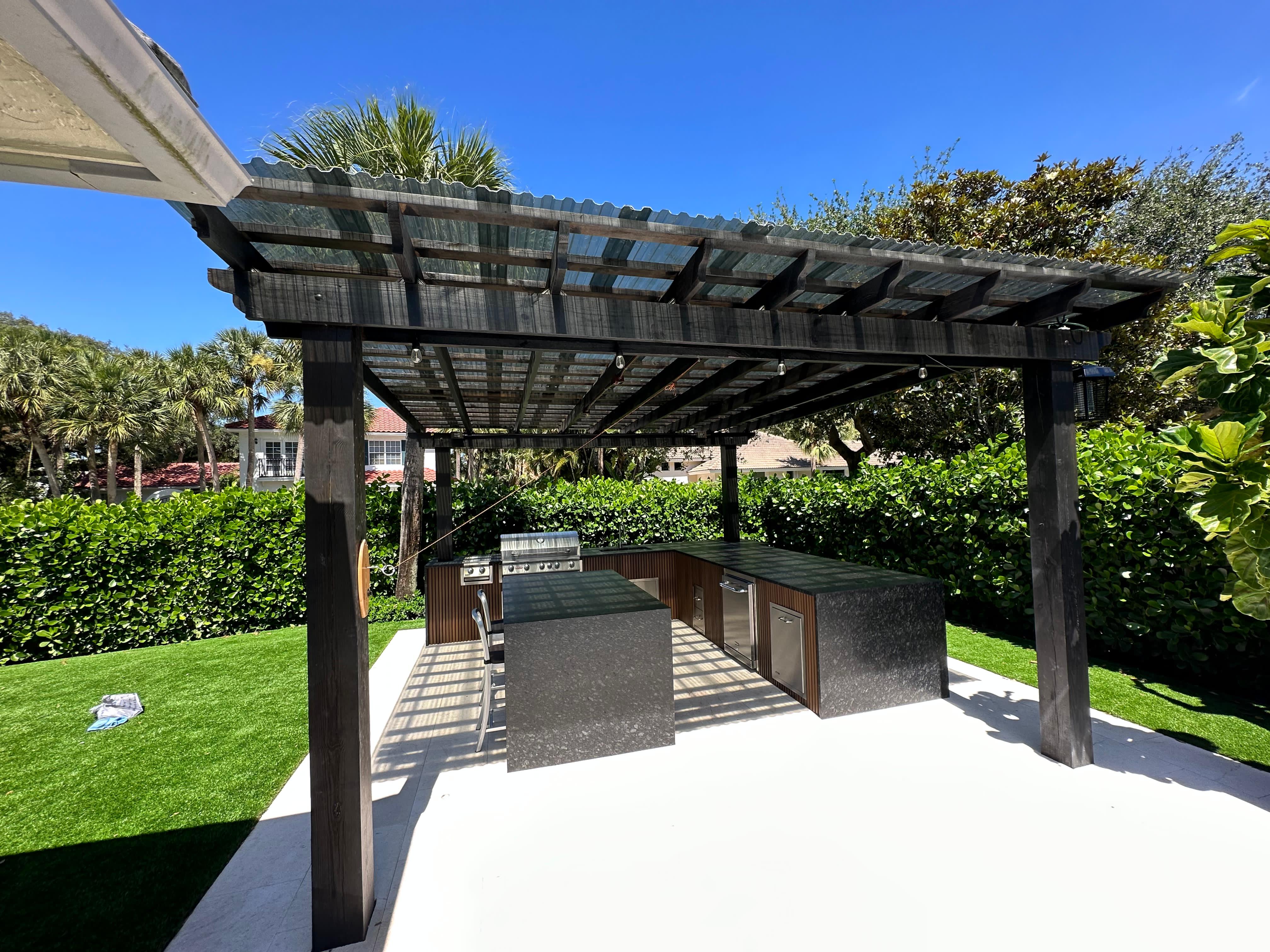Modern outdoor kitchen with granite and pergola