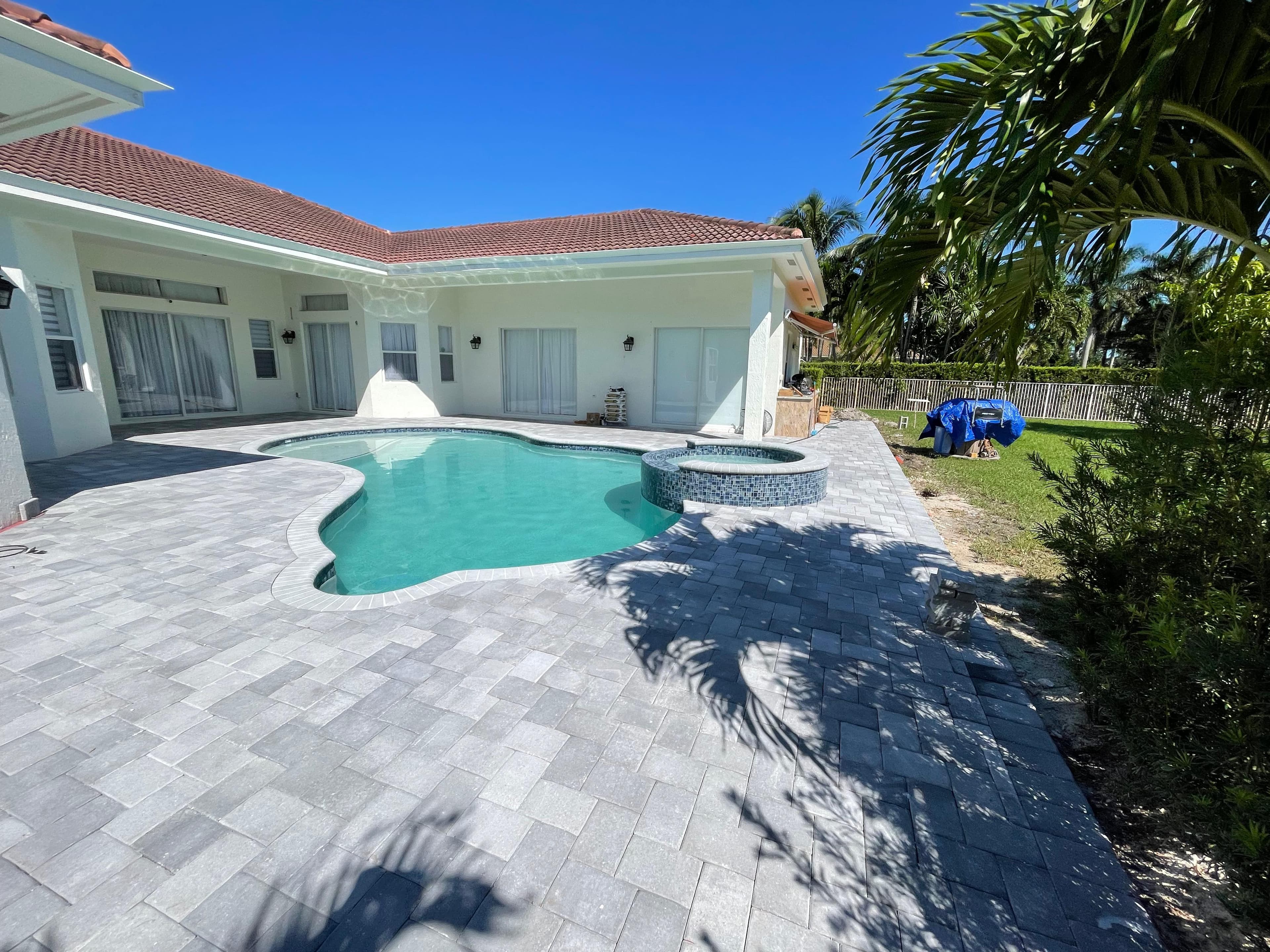 Pool and spa with mosaic tile pavers
