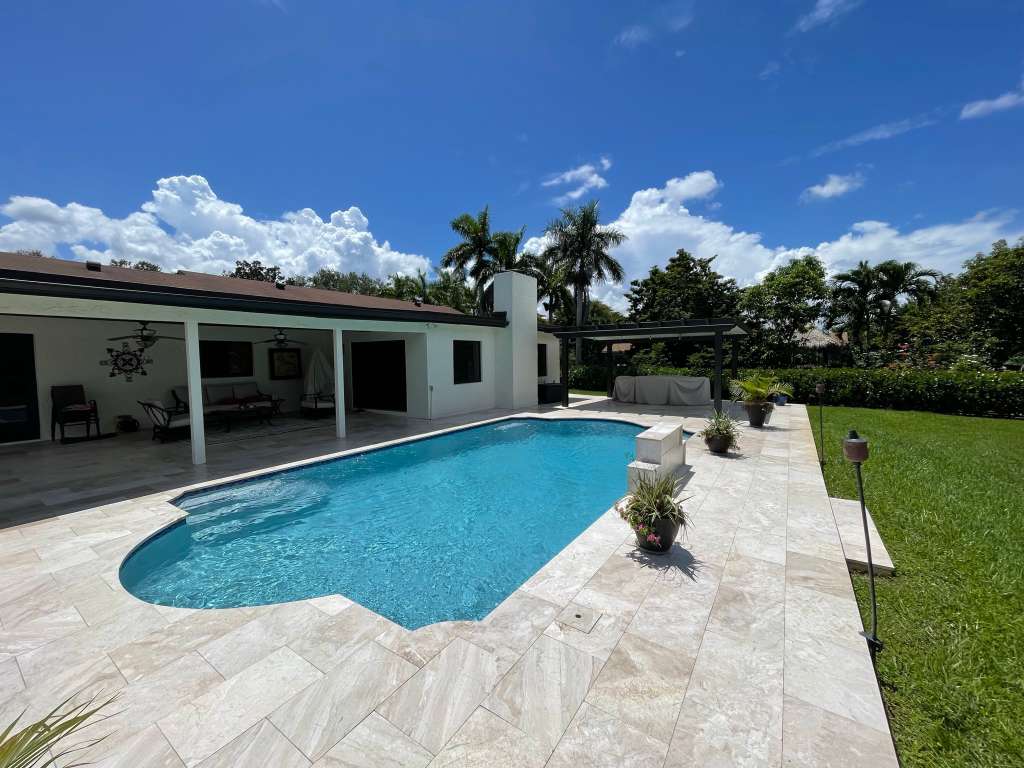 Pool with travertine deck and premium pavers